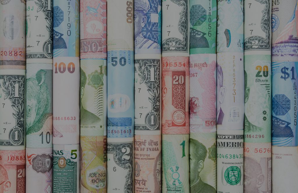 Rolls of currency from various countries representing finncial services translation