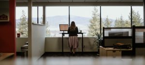 Christy working at the standing desk in the Glyph Language Services office space