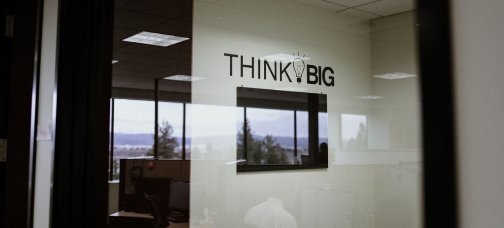 Think Big sticker on the wall at Glyph Language Services, Feel welcome to grab a translation services quote.